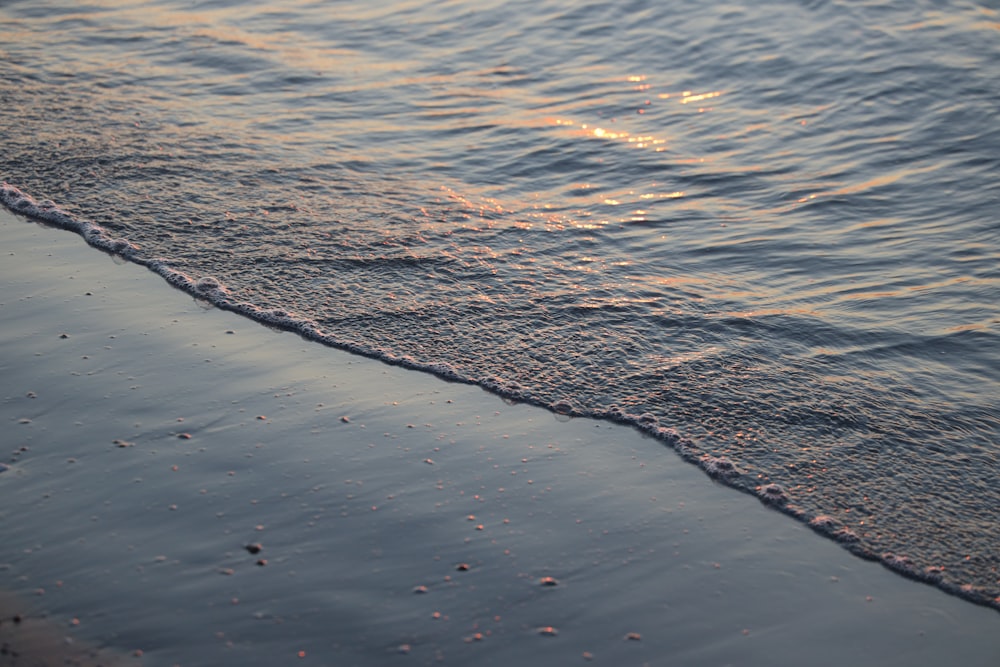 a beach that has some water and sand on it