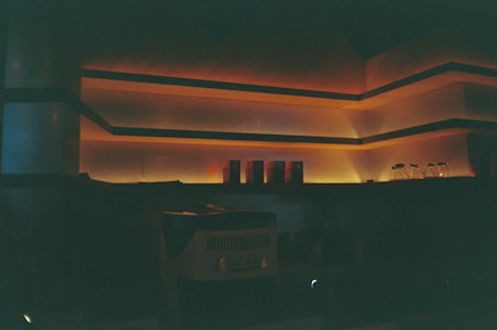 Modern residential interior softly illuminated with warm, ambient lighting highlighting architectural features.