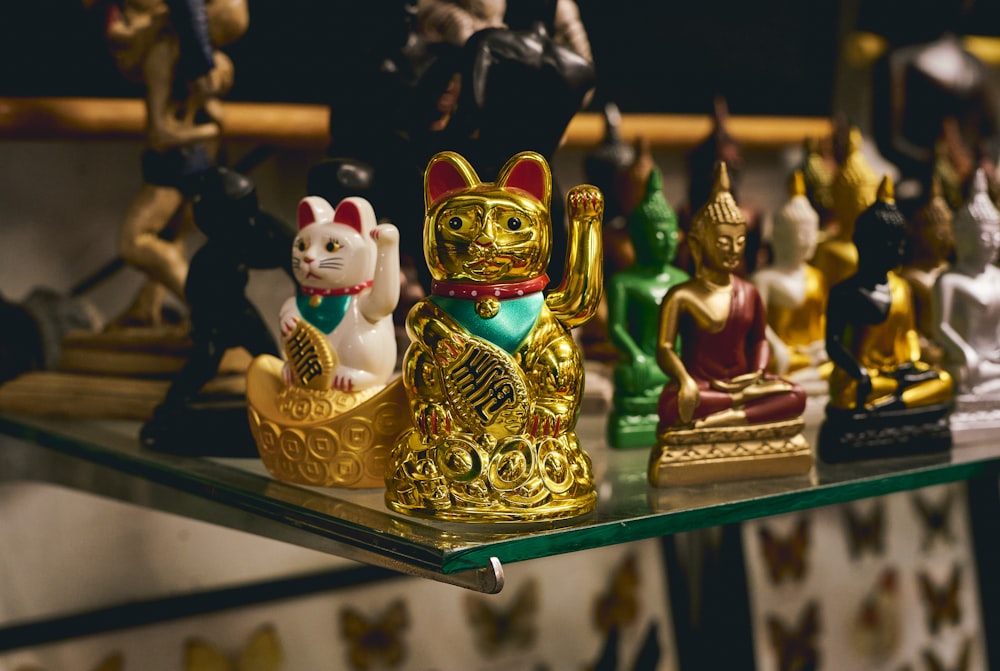 a glass shelf with a bunch of figurines on it