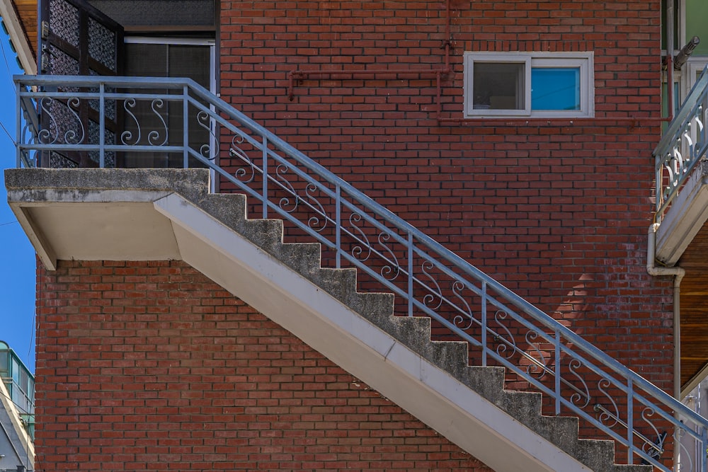 a red brick building with a metal hand rail