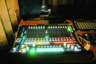 a sound mixing console sitting on top of a wooden table