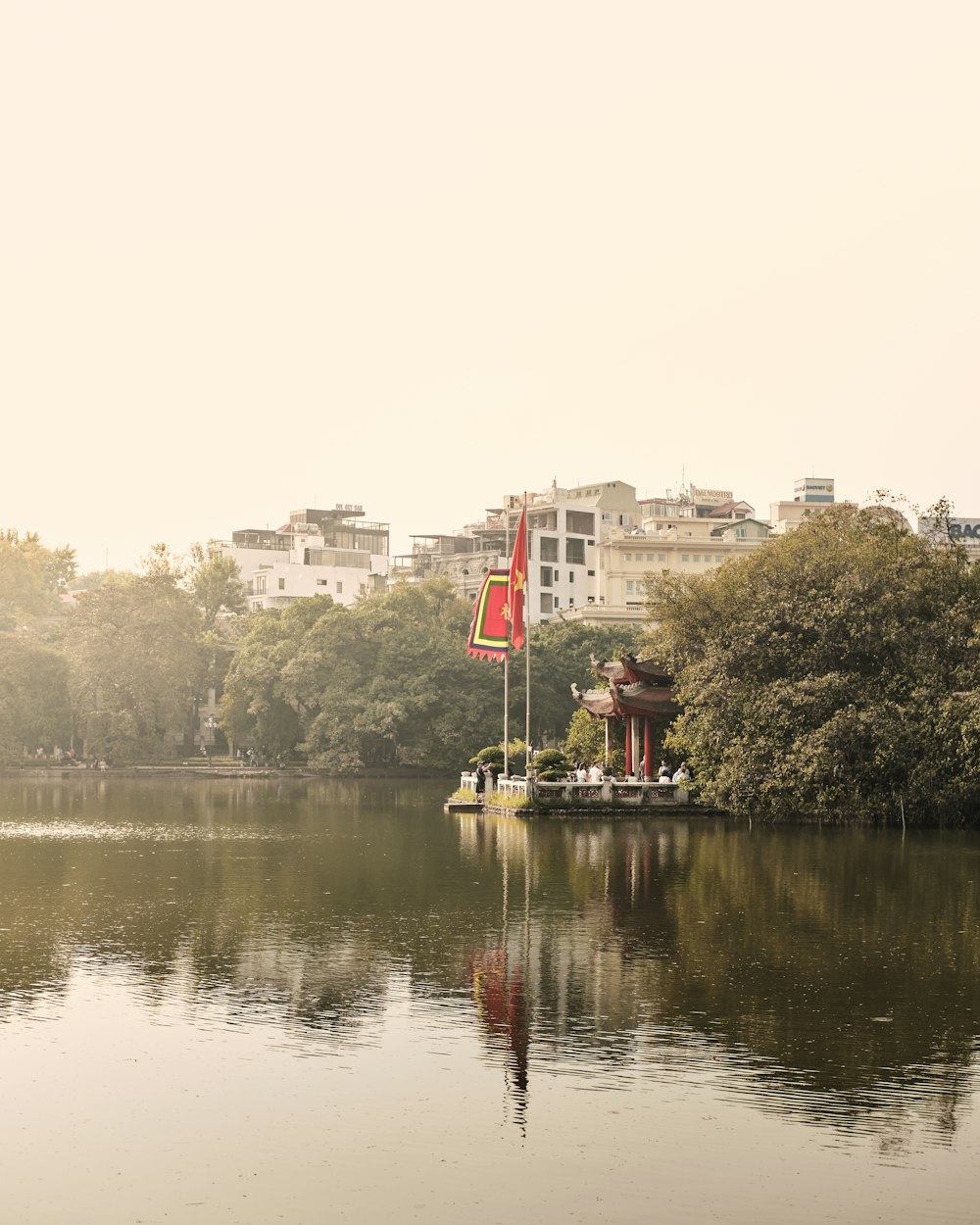 a body of water surrounded by trees and buildings