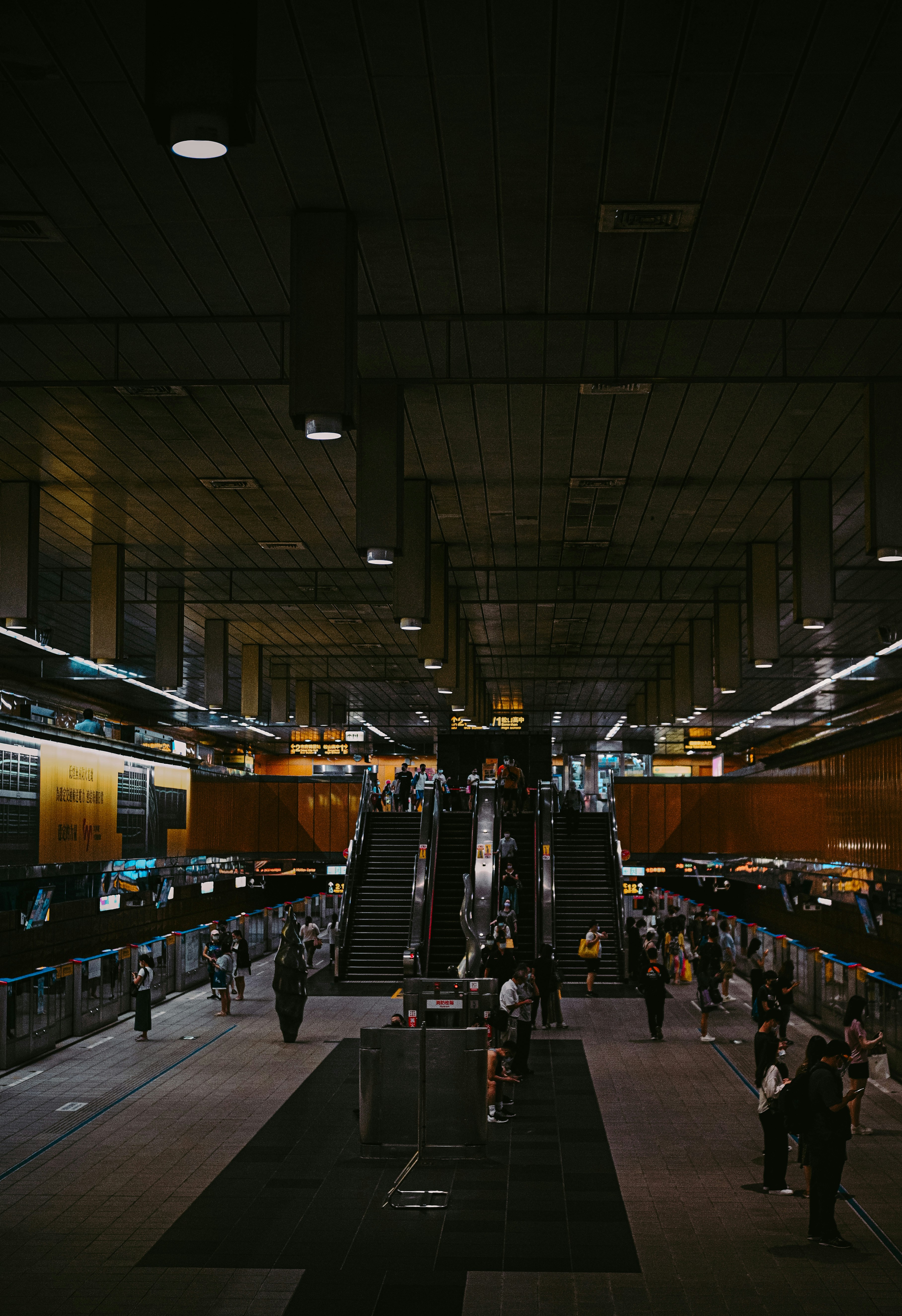 a group of people walking around a train station