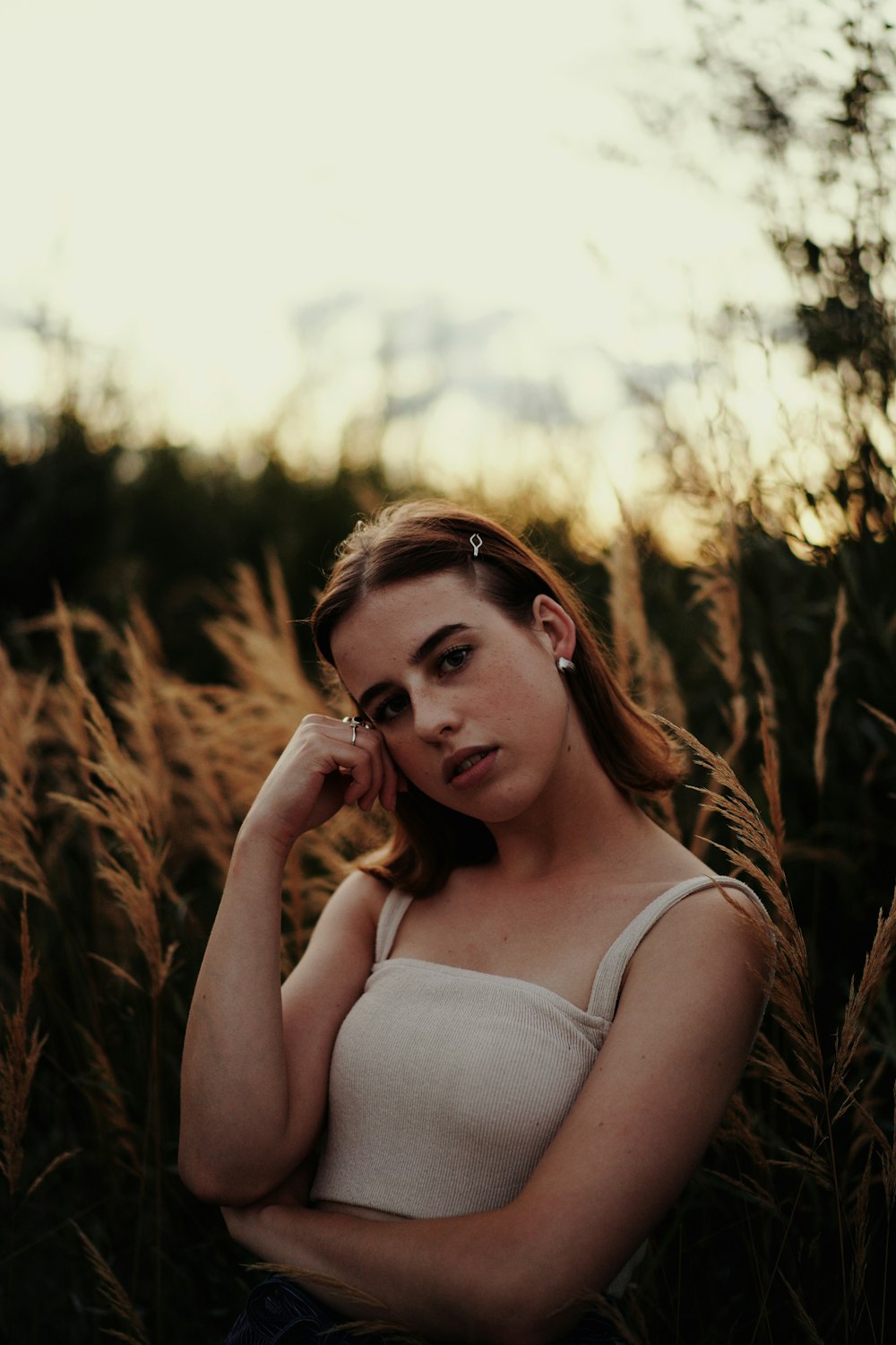 a woman standing in a field of tall grass