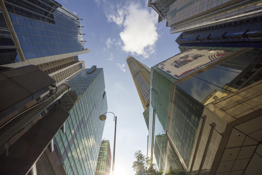 looking up at tall buildings in a city