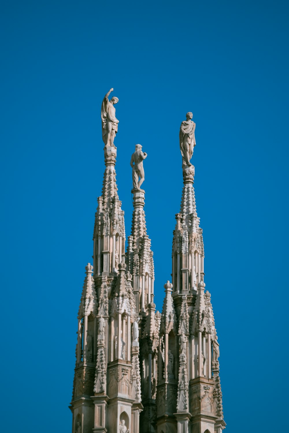 a tall building with statues on top of it