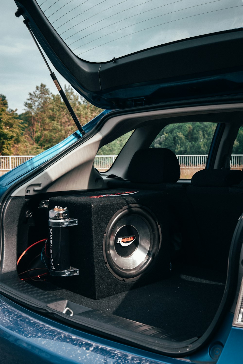 a car with a sub box in the trunk