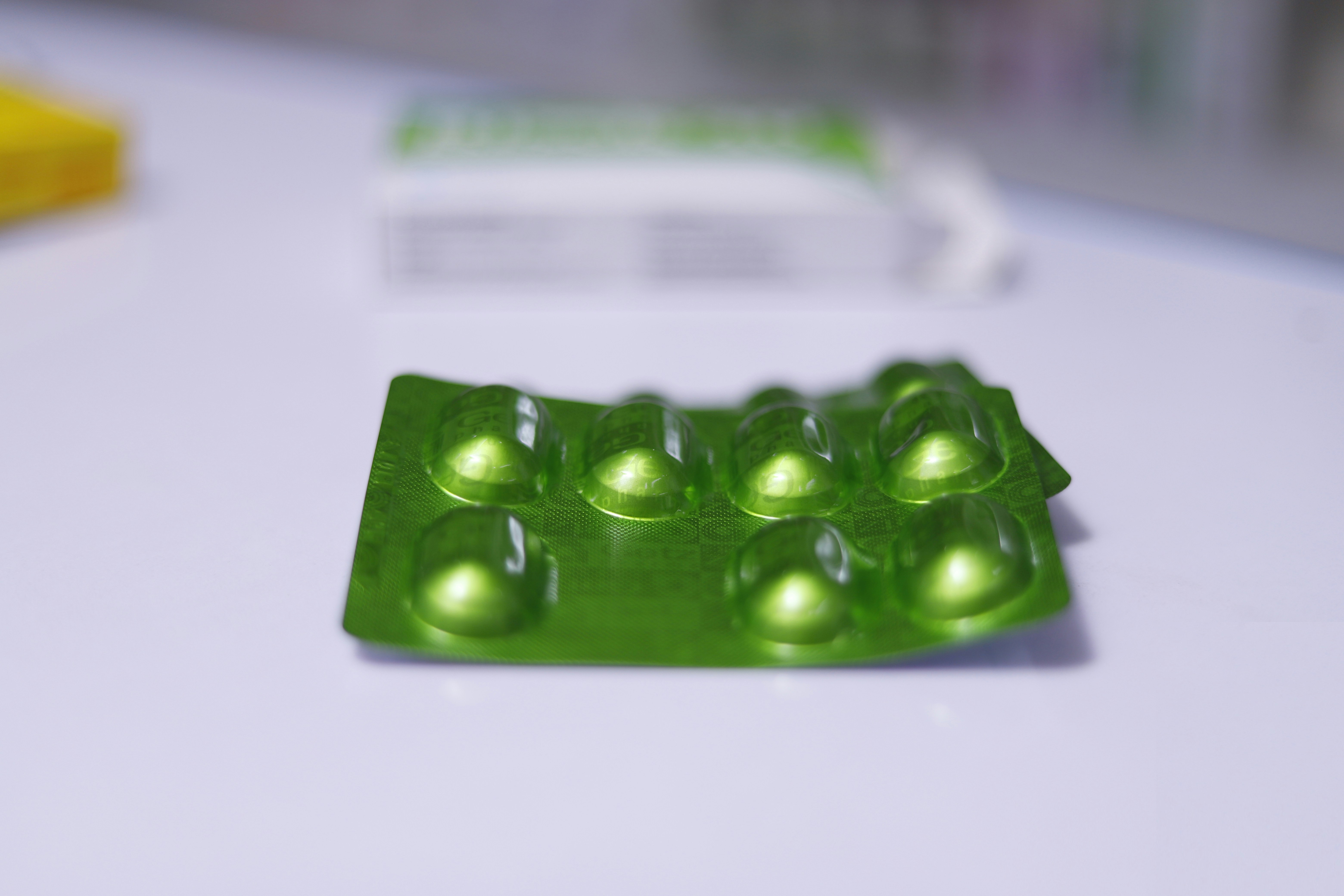 a group of green pills sitting on top of a table