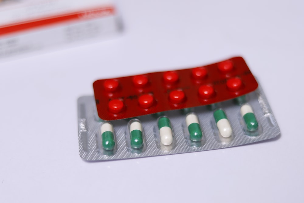 a red and green contraption sitting on top of a white table