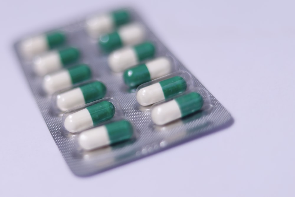 a pack of pills sitting on top of a white table