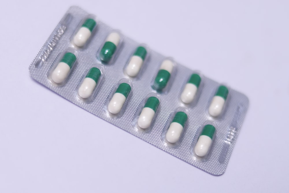 a pack of pills sitting on top of a white table