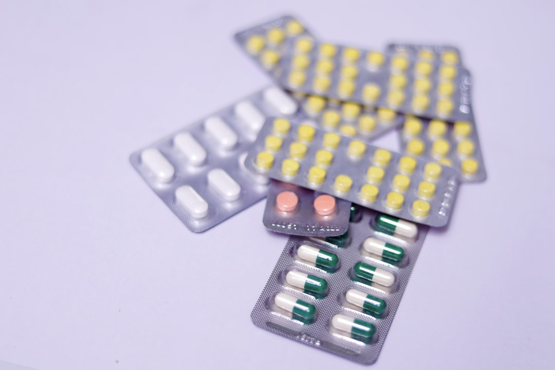 Assorted pills and capsules in blister packs on a light background