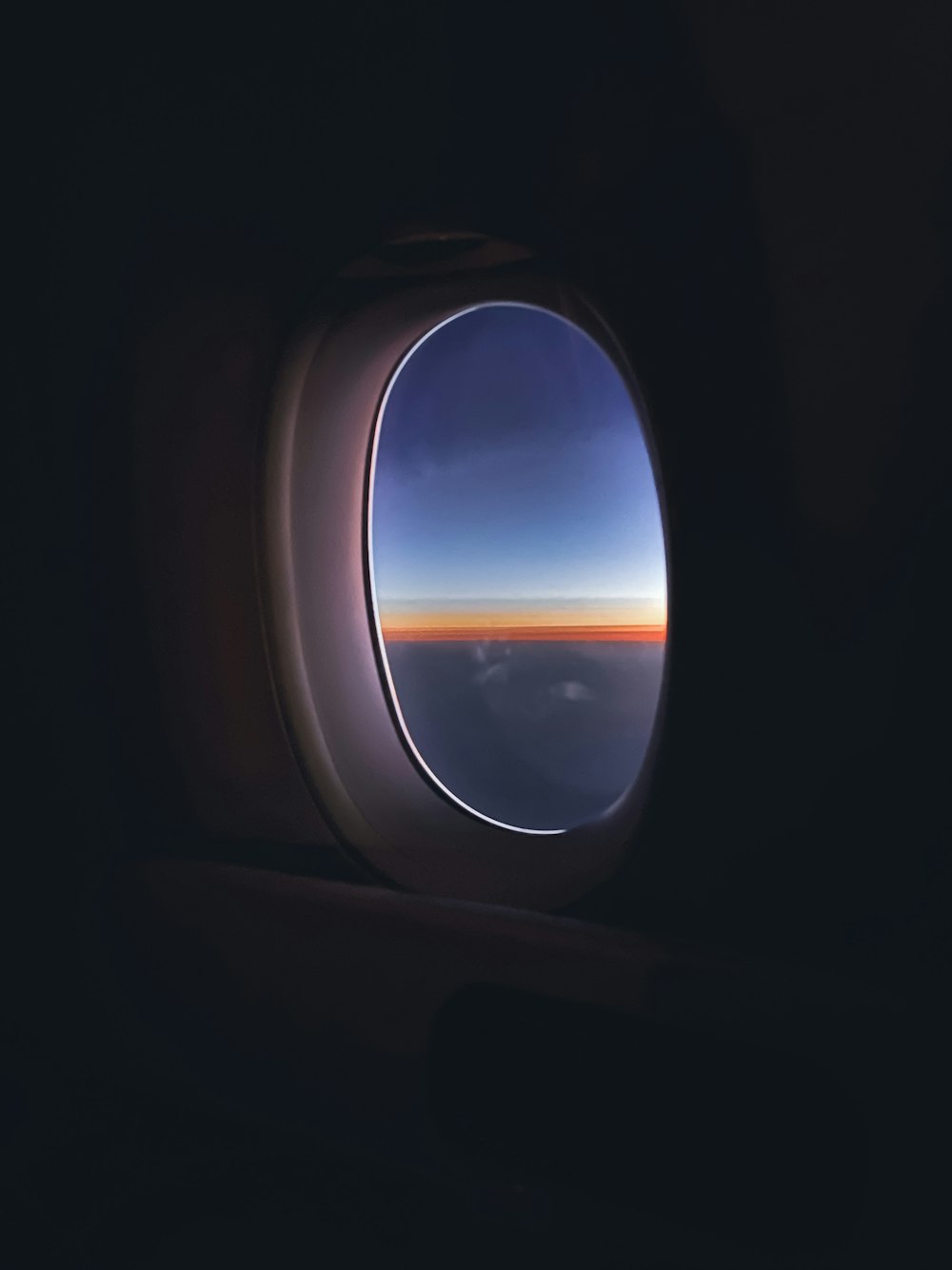 an airplane window with a view of the sky