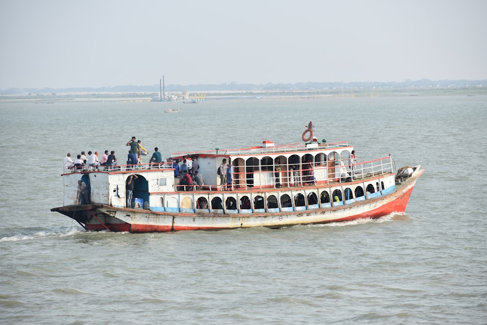 a large boat with people on it in the water