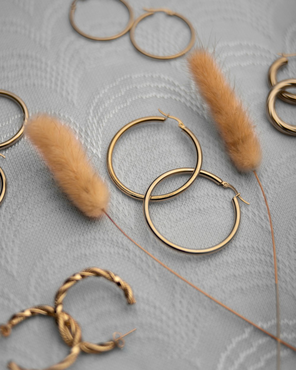 a close up of some gold rings and some feathers