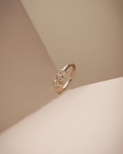 a diamond ring sitting on top of a white surface