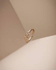 a diamond ring sitting on top of a white surface