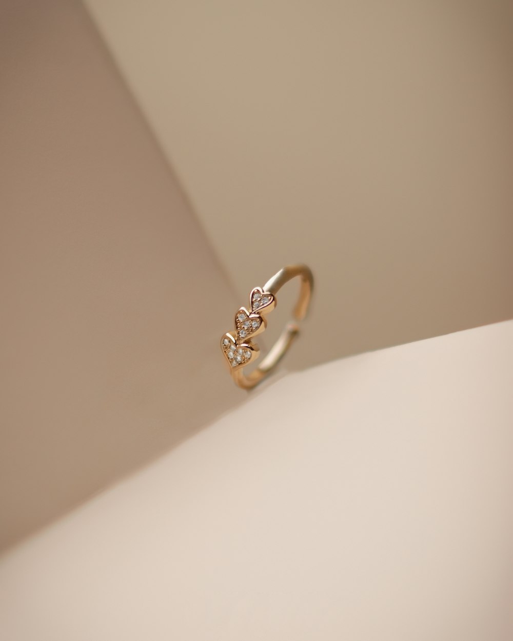 a diamond ring sitting on top of a white surface