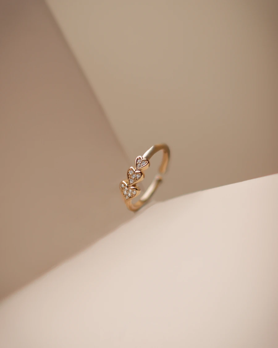 Mercer pavé huggie earrings in 14k gold on warm linen