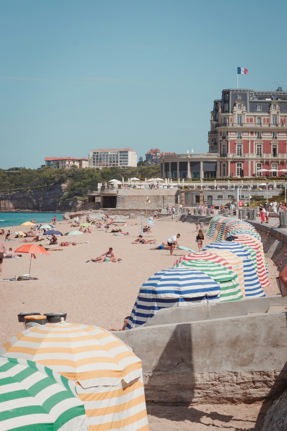 a beach filled with lots of people and umbrellas