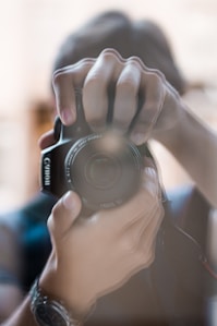 a person holding a camera up to take a picture