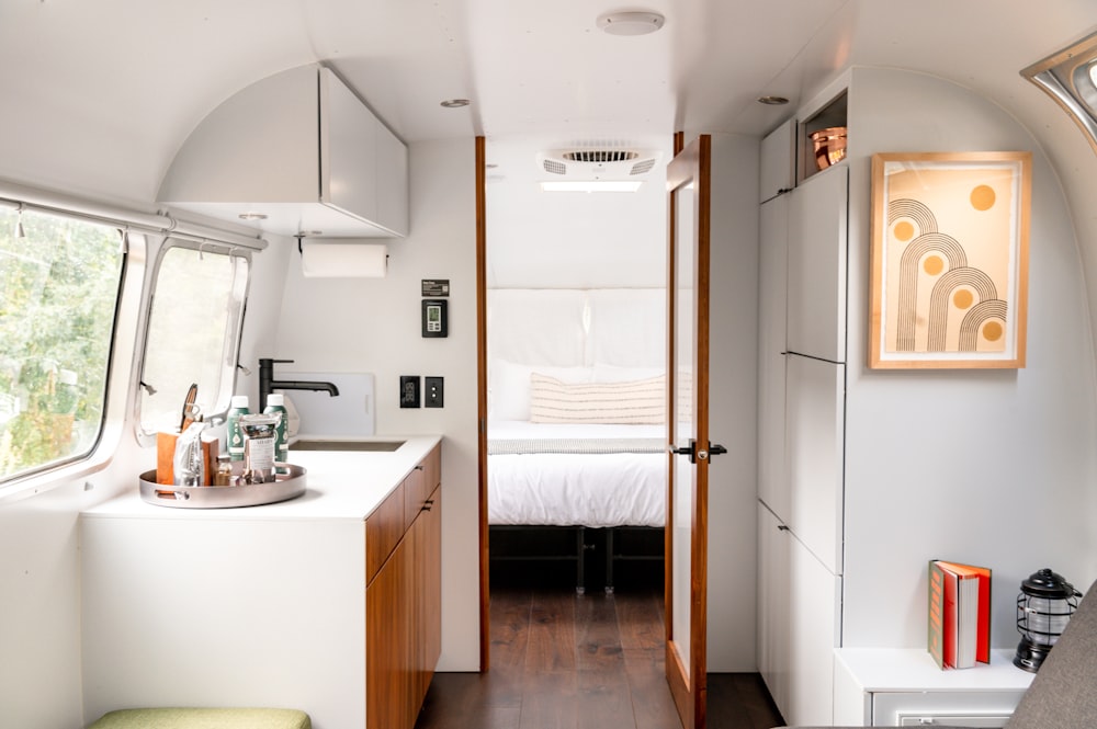 a bedroom and a kitchen inside of a bus