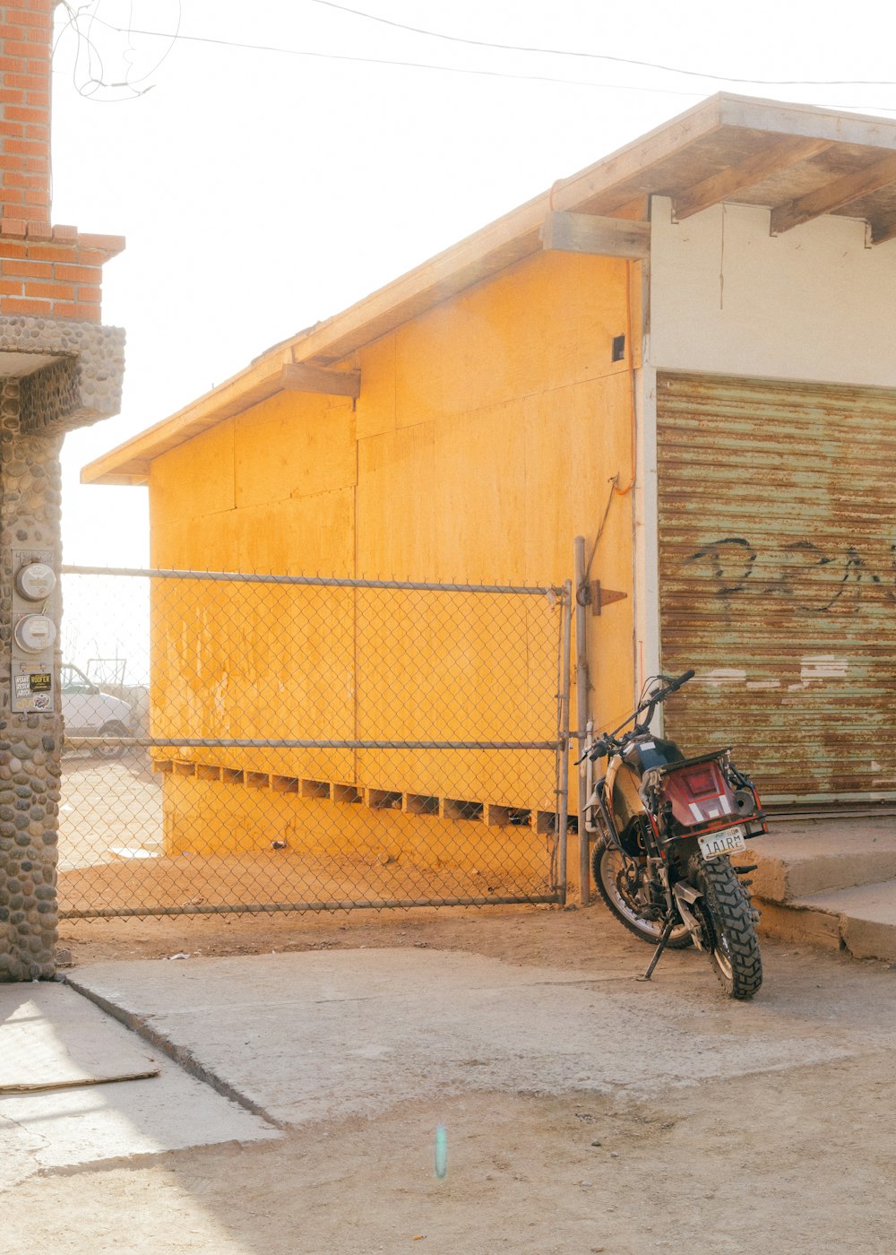 a motorcycle parked in front of a yellow building