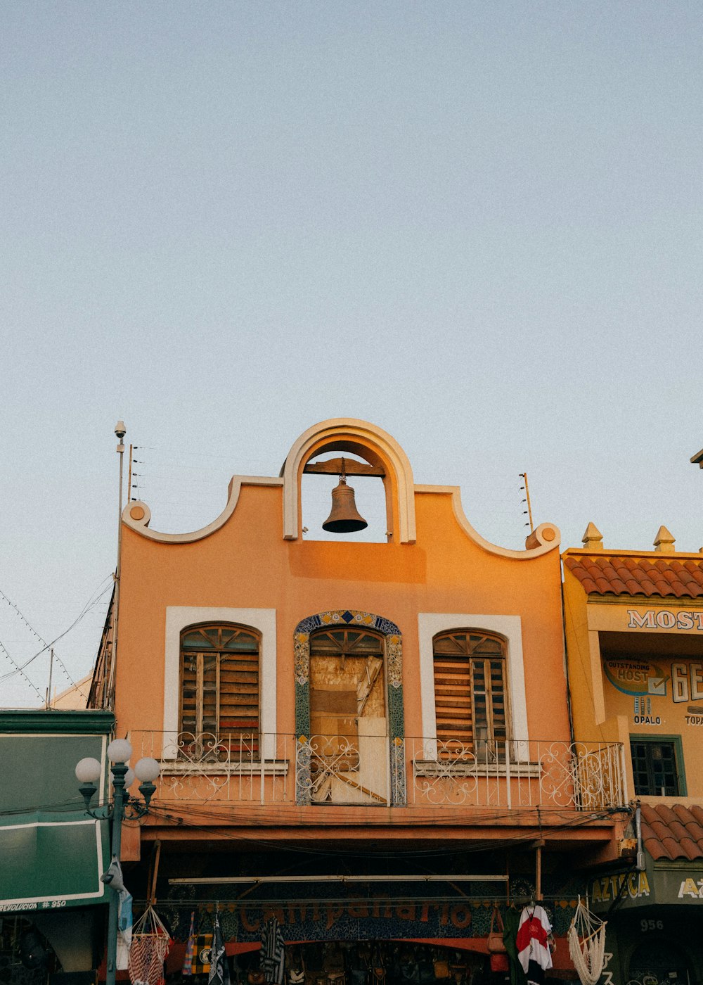 a building with a bell on the top of it