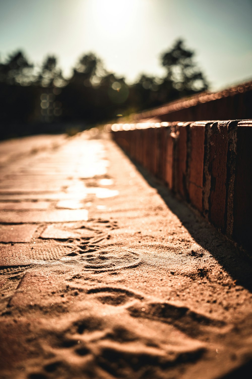 a close up of a brick wall with a sun in the background