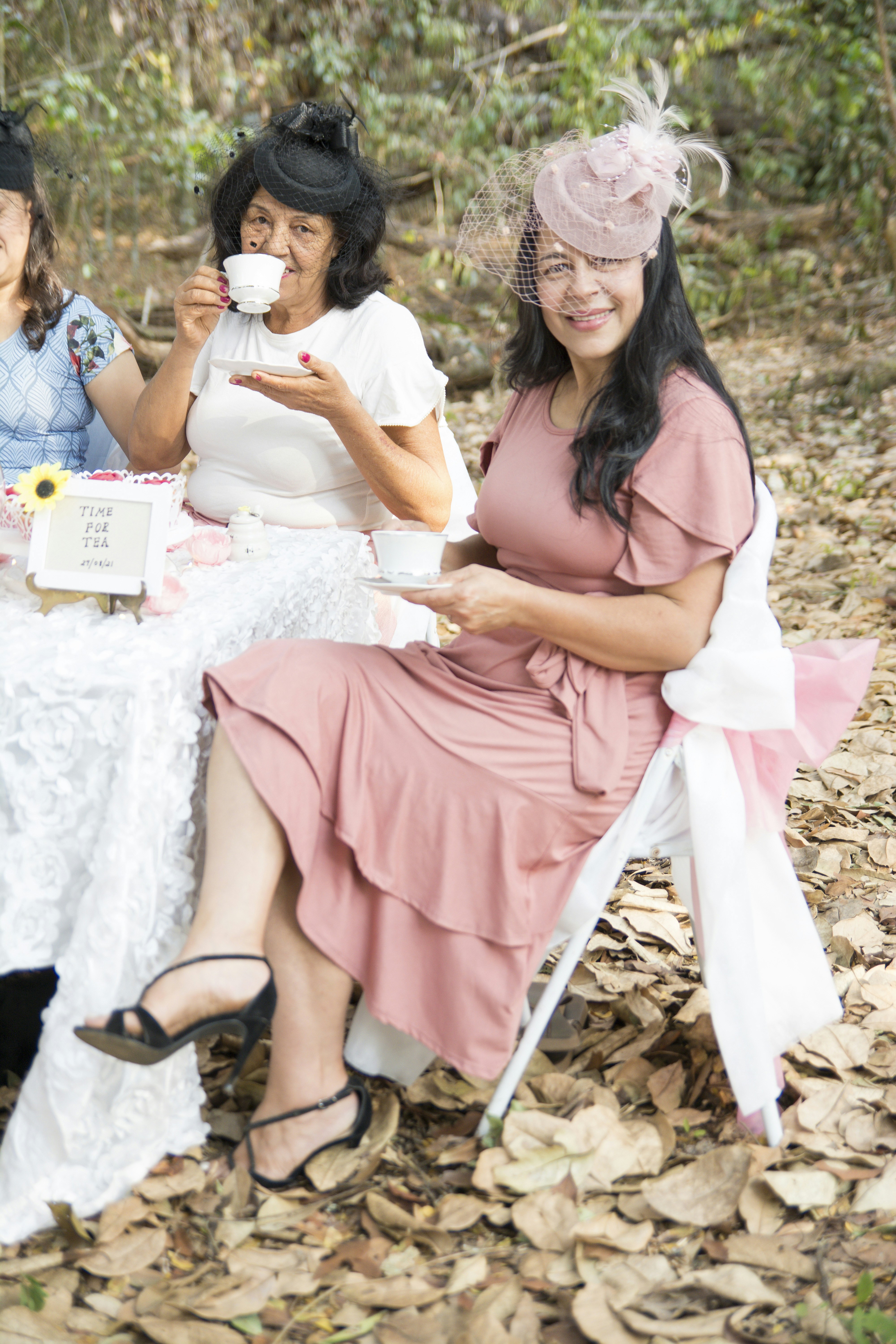 a group of women sitting around a table eating food