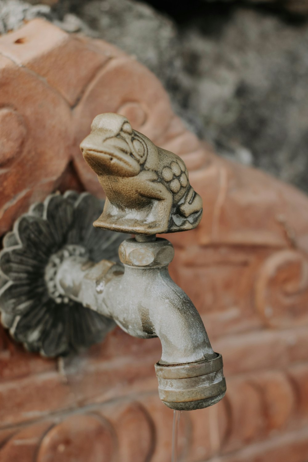 a close up of a faucet with a flower on it