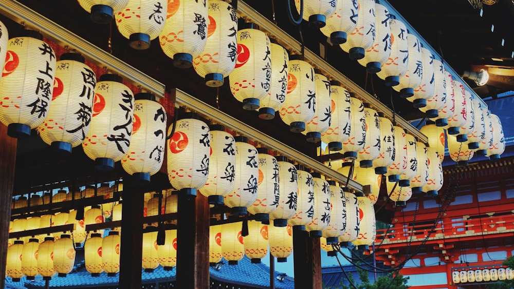 a row of lanterns with asian writing on them
