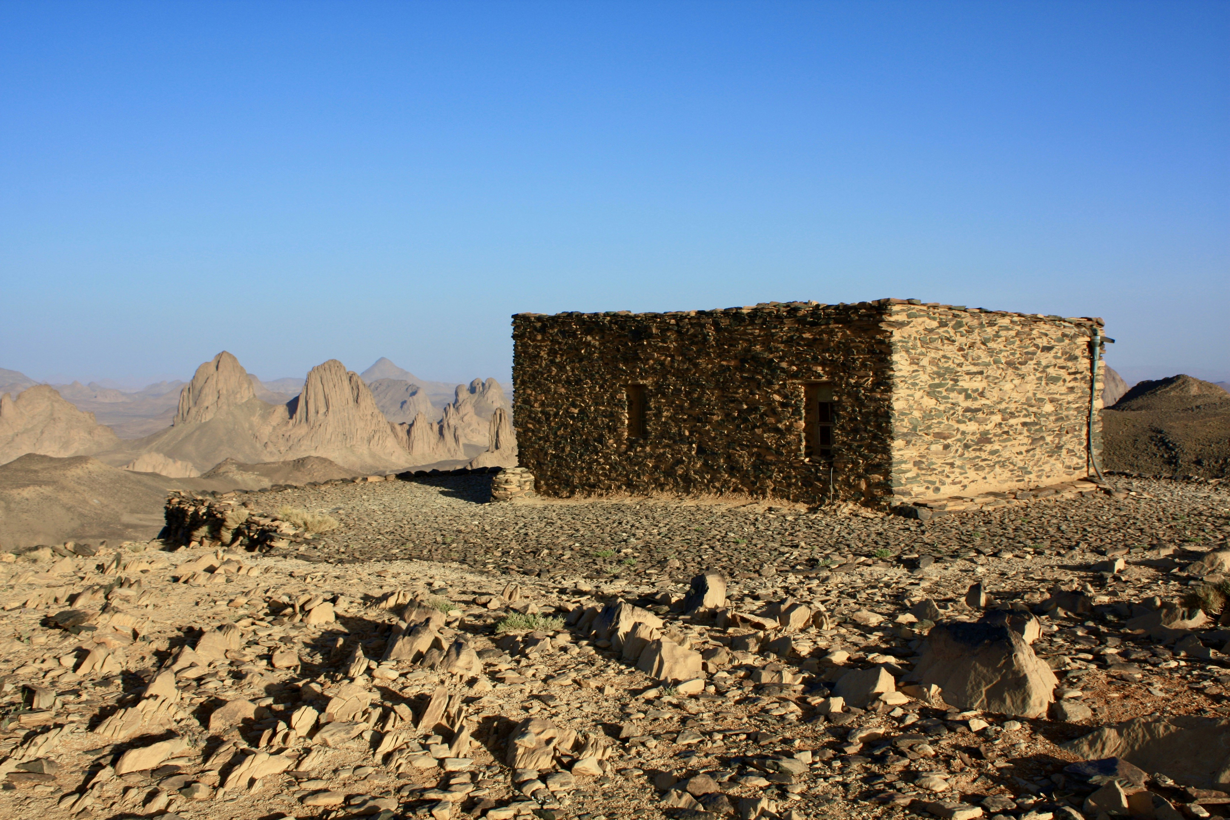 A stone building sitting on top of a rocky hillside