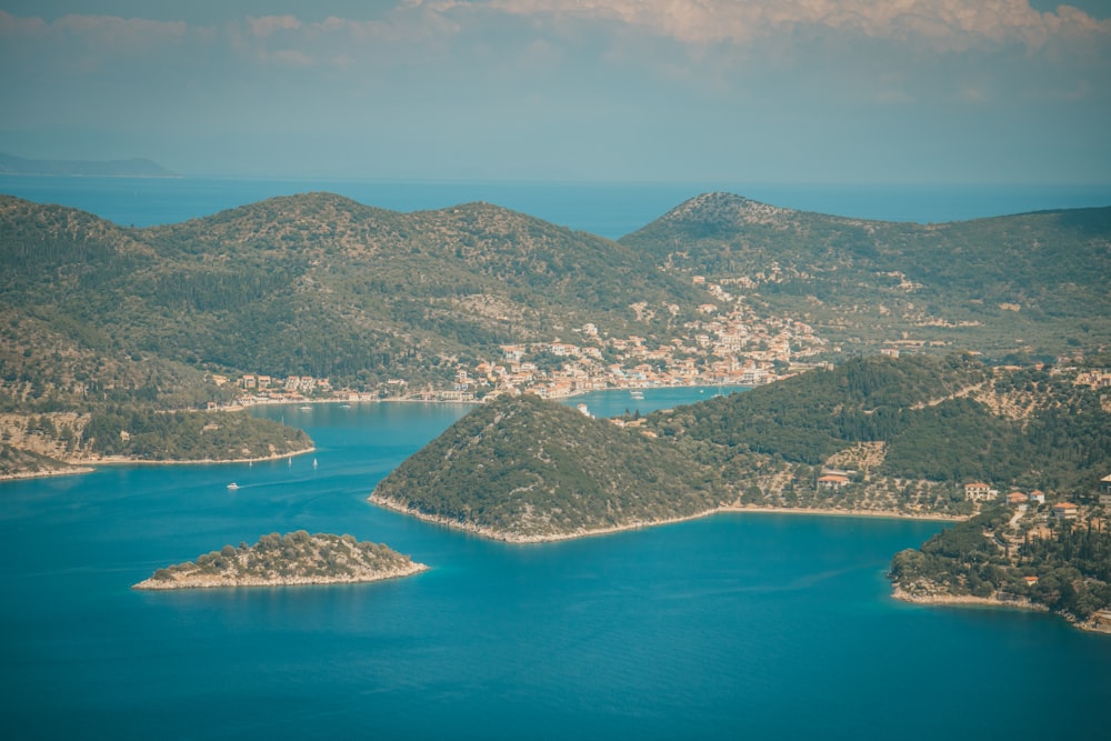 an aerial view of a lake surrounded by mountains