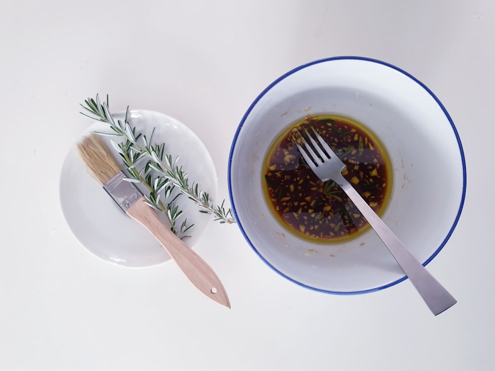 a bowl of olive oil and a fork