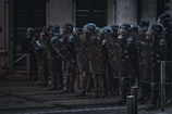 Security personnel practicing crowd control techniques in a simulated environment.