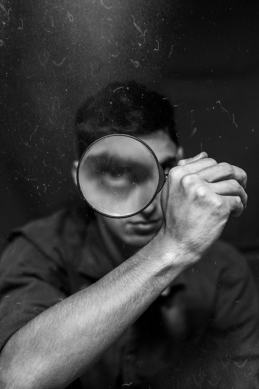 a man looking through a magnifying glass