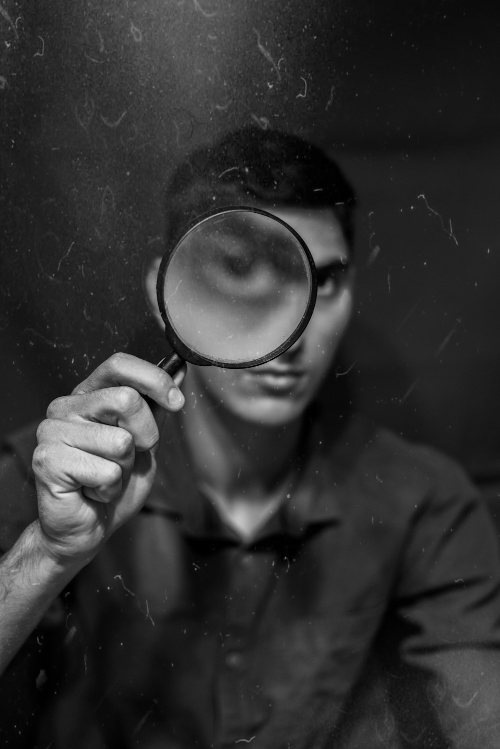 a man looking through a magnifying glass