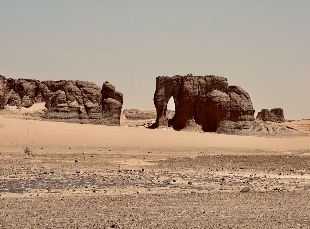 a large rock formation in the middle of a desert