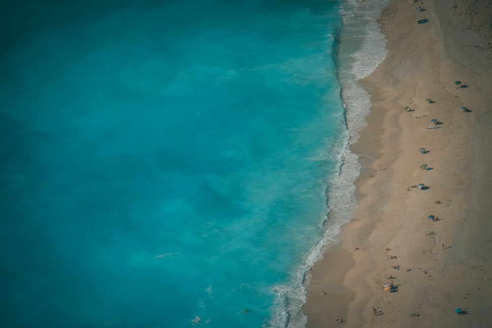 an aerial view of a beach with a body of water