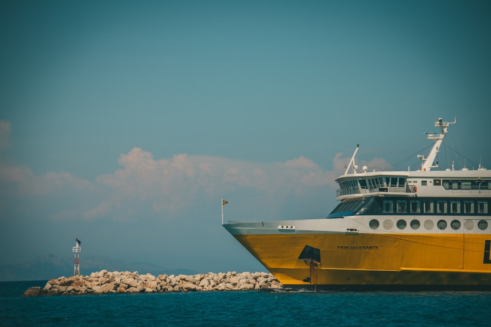 a large yellow and white boat in the water