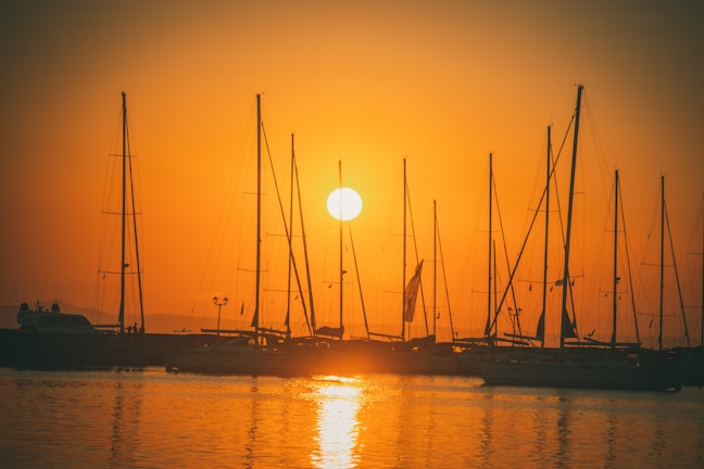 Sunset casting golden hues over a sleek yacht cruising smooth Pattaya waters.