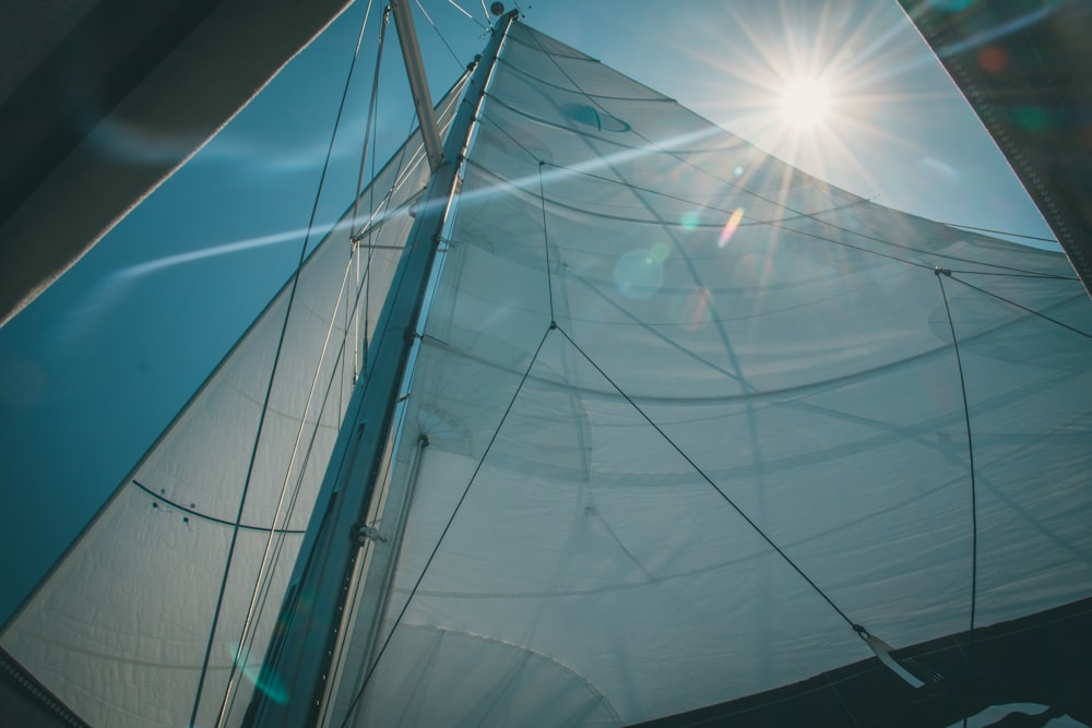 a sailboat with the sun shining through the sails