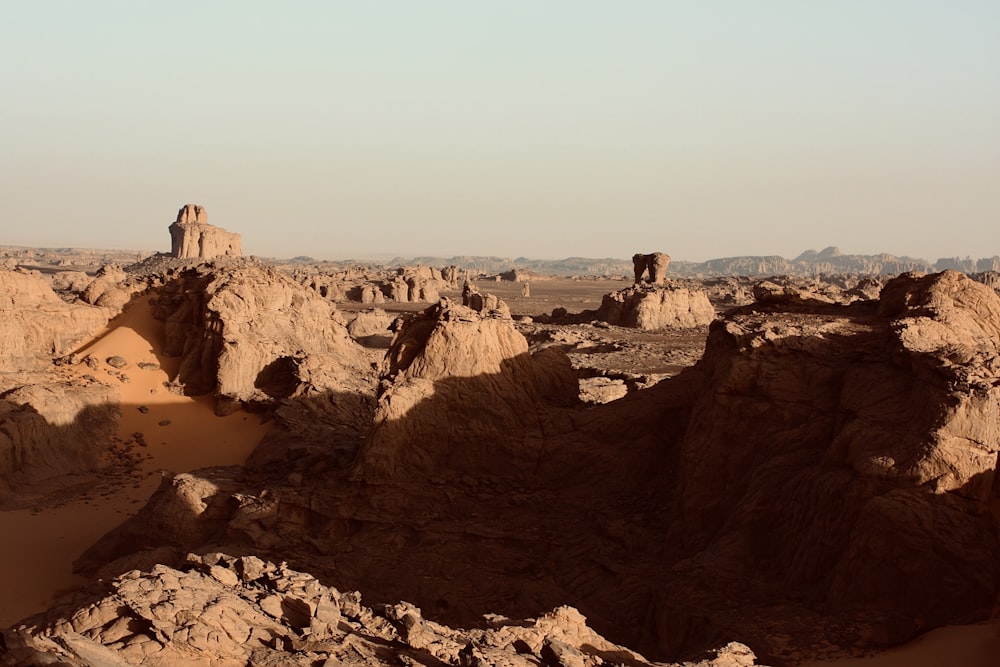 a rocky landscape with a person standing on top of it