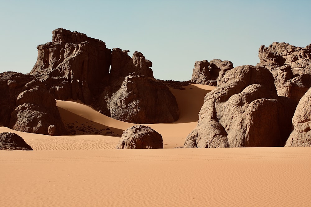a group of large rocks in the middle of a desert