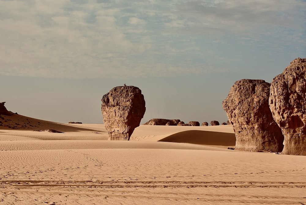 a group of rocks sitting in the middle of a desert