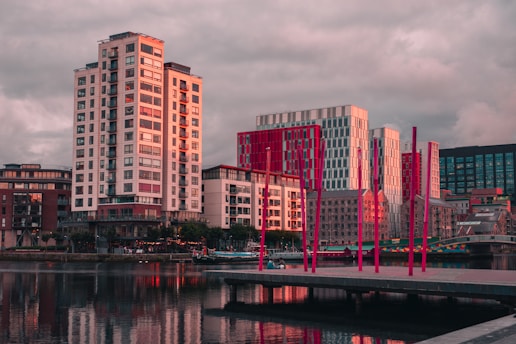 a body of water with buildings in the background