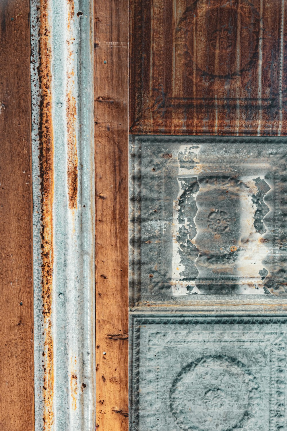 a close up of a wooden door with peeling paint