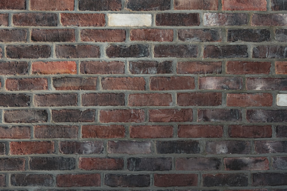 a brick wall with a clock on the side of it