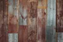 a close up of a wooden wall with a clock on it